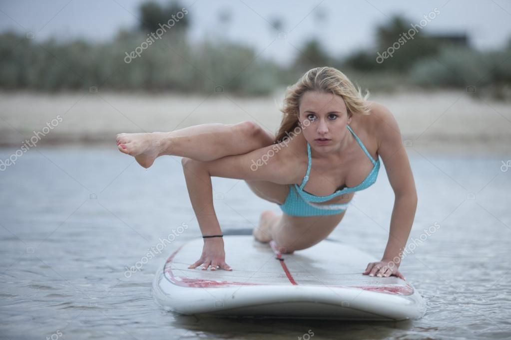 A portrait a sexy young model doing Sup Yoga. Stock Photo by ©davidewingphoto 62736147