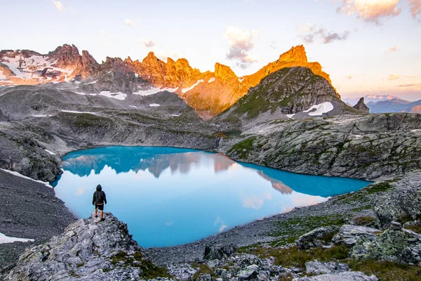 Adventurous Man Standing Cliff Overlooking Beautiful Swiss Rockies Wildsee Lake Stock Picture