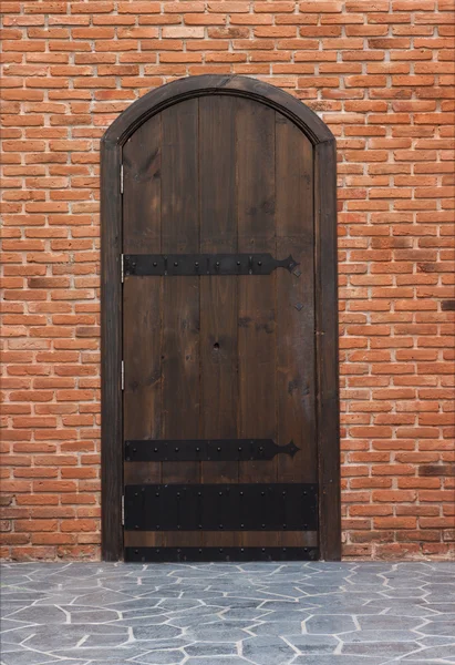 Vecchia porta in legno con pareti in mattoni rossi . — Foto Stock