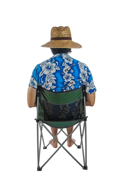 Hombre con sombrero, sentado en una silla . — Foto de Stock