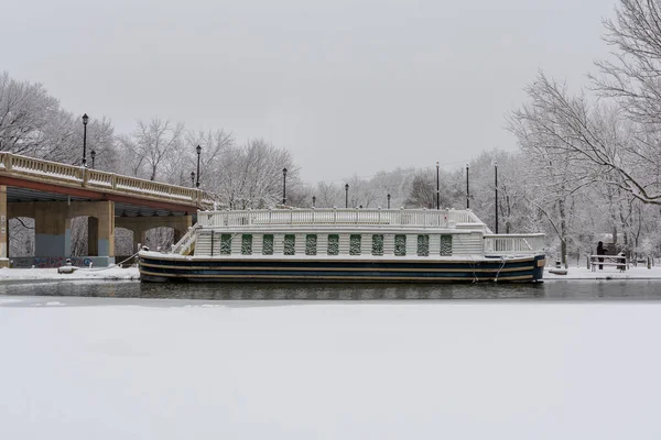 Old canal boat moored for winter at lock 14 in LaSalle on a frosty snowy winter day.