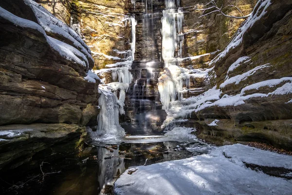 A frozen Lake Falls in the snow covered Lower Dells area of Matthiessen state park.  Illinois, USA.