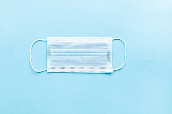 Medical face masks with on a blue background with copy space. Coronavirus pandemic prevention concept. Flat lay — Stock Photo, Image