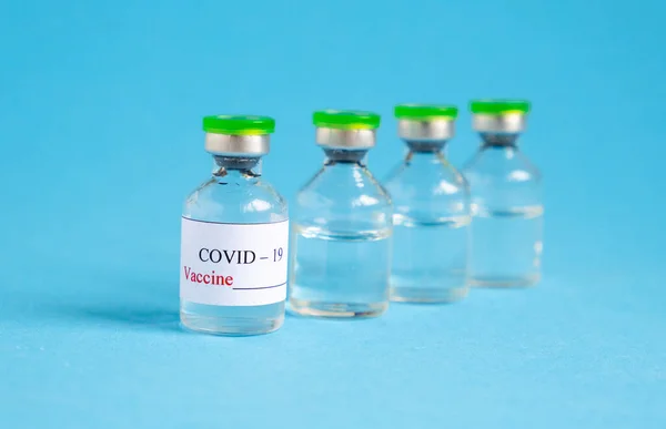 Coronavirus COVID-19 Vaccine Vials On Blue Background — Stock Photo, Image