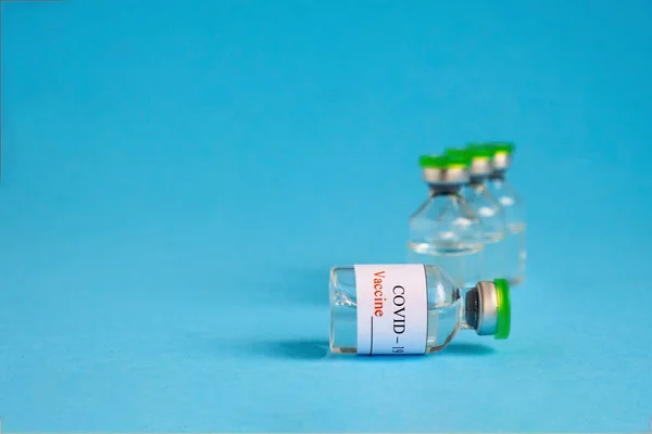 Coronavirus COVID-19 Vaccine Vials On Blue Background — Stock Photo, Image