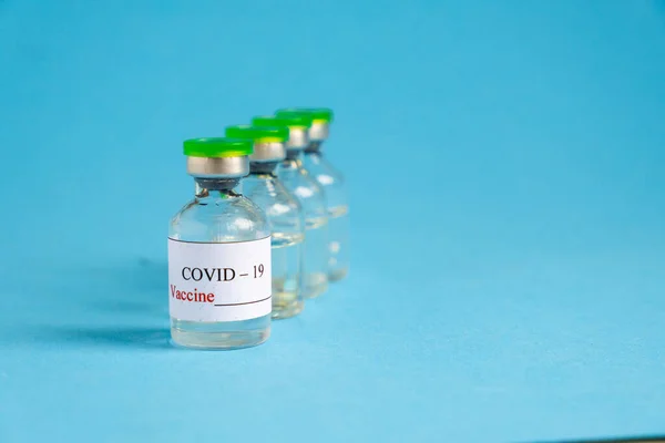 COVID-19 Vaccine On Blue Background — Stock Photo, Image