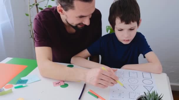 Autism boy during therapy with his school tutor, learning together. Autism childhood mental illness therapy concept — Stock Video