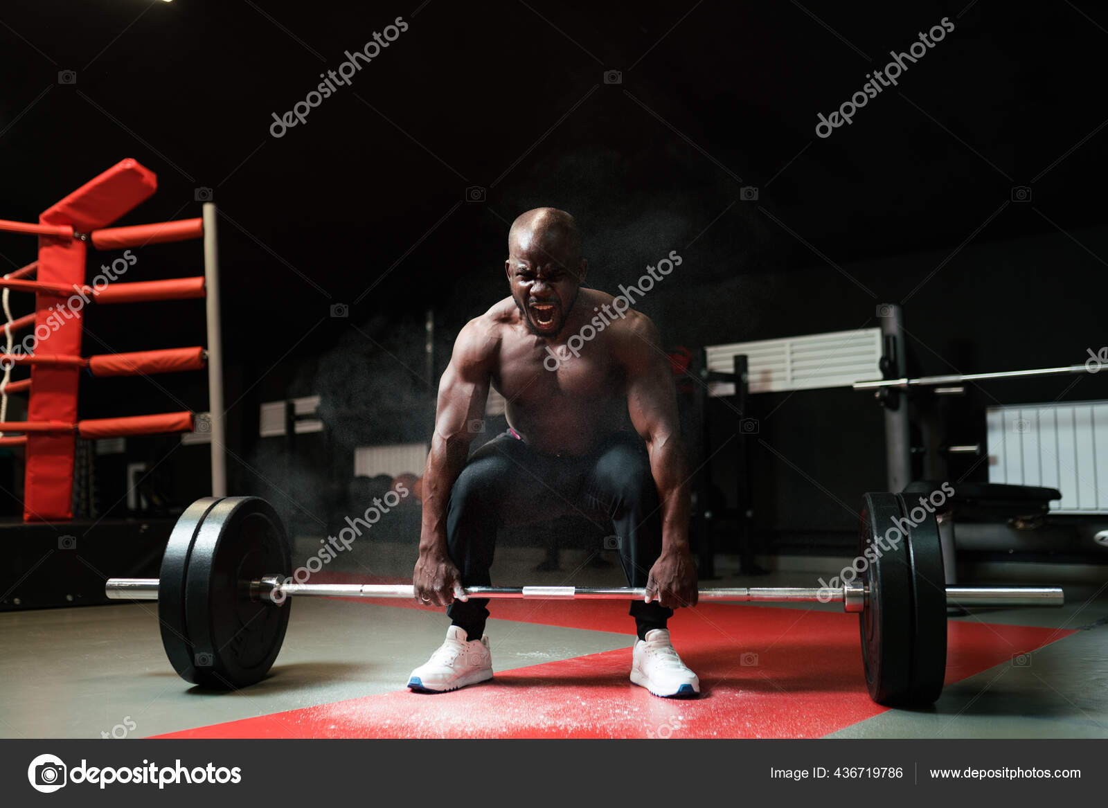 Man doing barbell The powerlifting coach screams and lifts