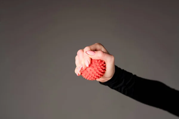 stock image Close-up photo. The girls hand holds a rubber ball to relax muscles after training