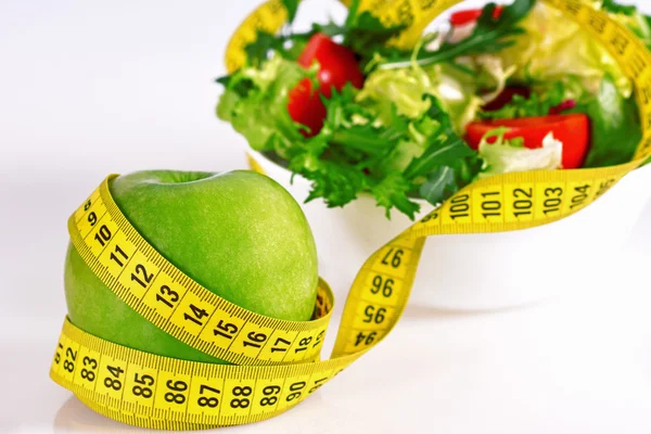 Diet concept - green apples, lettuce, pills and  measure tape Royalty Free Stock Photos