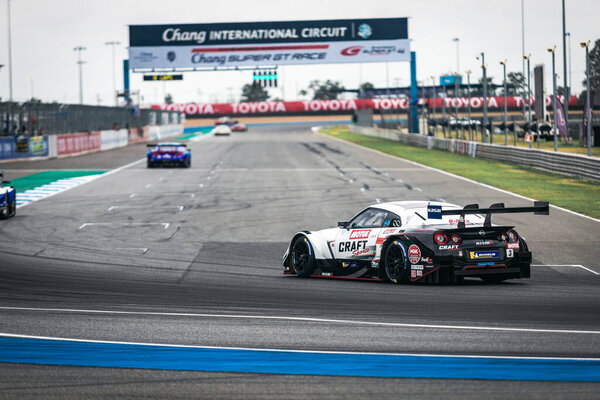 Buriram, Thailand - 29 June 2019 : Thailand SuperGT racing match, GT300 and GT500 match start day, Kasai team racing car driving on the stadium with the match post of Chang international circuit