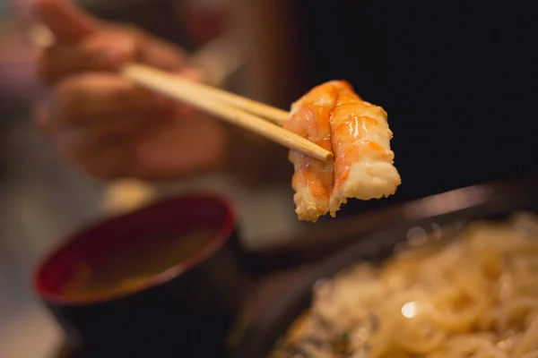 女服务员用筷子把大虾捞上来吃 配以海味的荷包子 来自日本的冷面条配以螃蟹 瘦肉配米索汤 — 图库照片