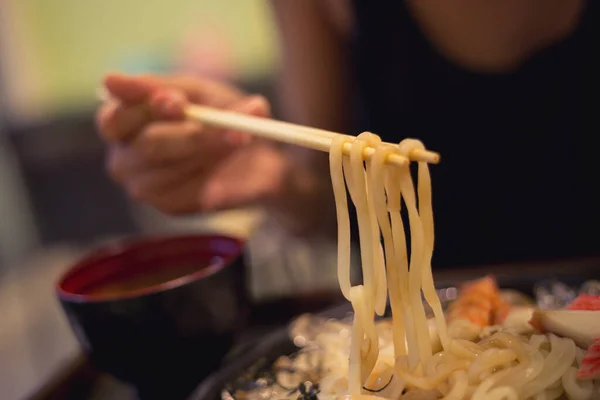 衣帽间的女士用筷子端上来吃 配以海味的荷包子 来自日本的冷面条配以螃蟹 瘦肉配米索汤 — 图库照片