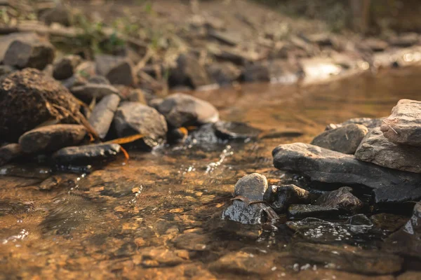 水の蒸気が流れる川で堰を作るために使用される石の近くに — ストック写真