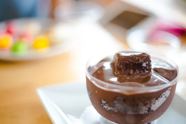 chocolate cake creamy inside a cup with part of cake on top