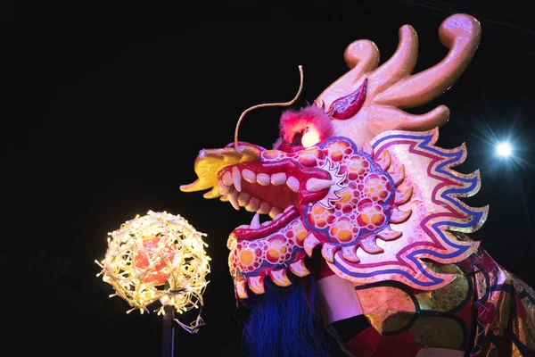 dragon head model with a light ball in chinese new year festival at night, have rim light