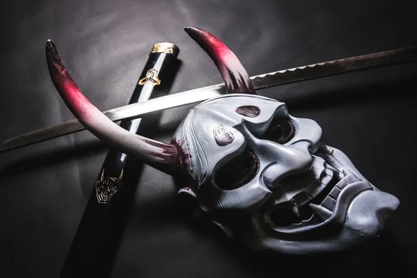 Japanese oni mask or giant mask, used to decorate handmade from original to make it look dark and art, put on katana sword