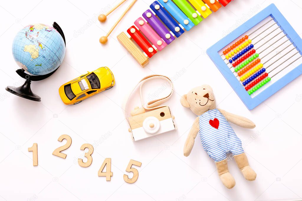 Colorful kids toys on white background. Top view, flat lay.