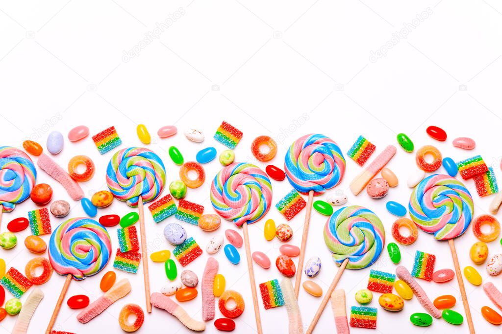 Mixed collection of colorful candy, on white background. Flat lay, top view