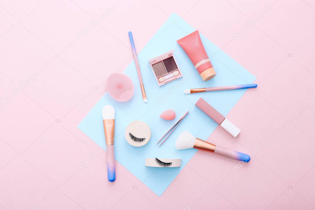 Makeup tools and accessories on blue and pink background. Beauty concept. Flat lay composition, top view