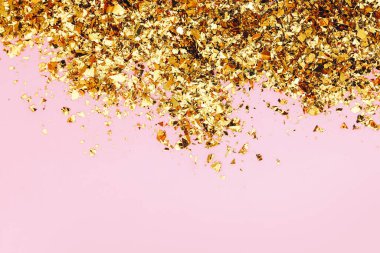 Pembe arka planda altın konfeti. Tatil arkaplanı, üst görünüm