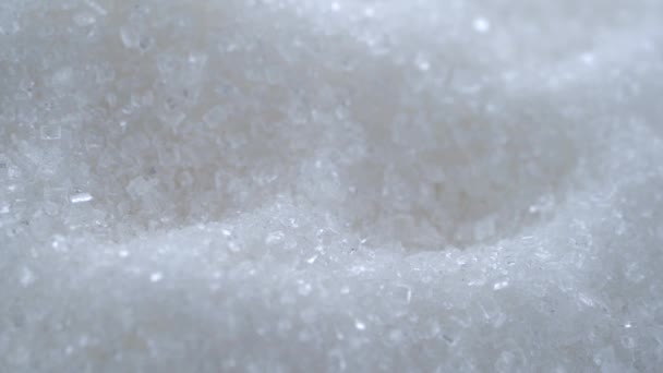 Mountains of white crystalline sugar shine beautifully and rotate — Stock Video