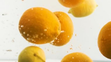 Limonlar ve portakallar suda. Bir sürü meyve..