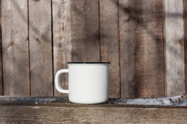 Ahşap arka planda beyaz bardak. Minimalist doğal tasarım.