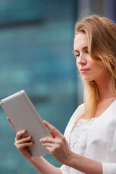 Beautiful woman with electronic tab in the street