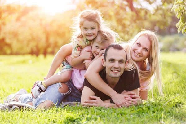 Family playing in the park on the grass — Stock Photo, Image
