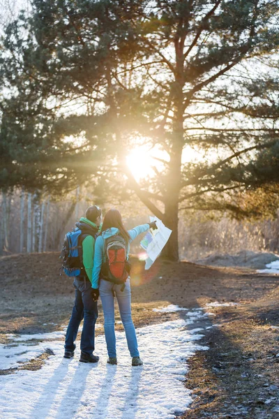 Hiking couple in spring forest.