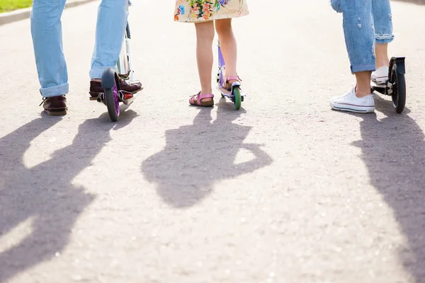 Parents and kid standing with scooters. — Stock Photo, Image