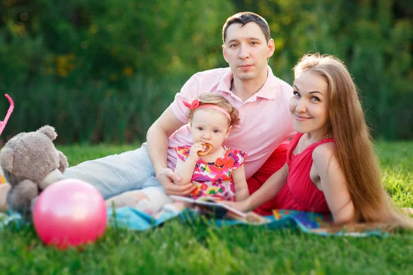 Happy young family spending time outdoor on summer day — Stock Photo, Image