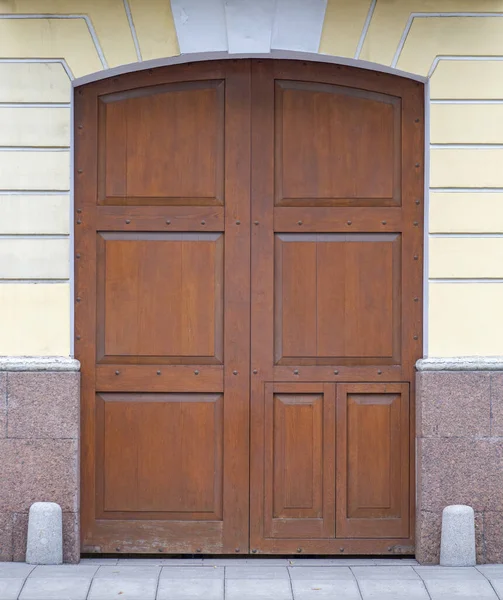 Old beautiful wooden door on the street. Royalty Free Stock Images