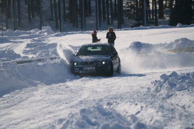 05-02-2021 RIga, Letonya. Aşırı sürüş, araba yumuşak karın üzerinde hızla hareket ediyor ve bir kar püskürtüsü oluşturuyor.