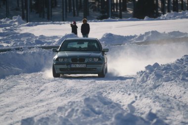 05-02-2021 RIga, Letonya. Aşırı sürüş, araba yumuşak karın üzerinde hızla hareket ediyor ve bir kar püskürtüsü oluşturuyor.