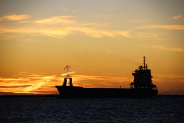 Gün batımında bir geminin silüeti..