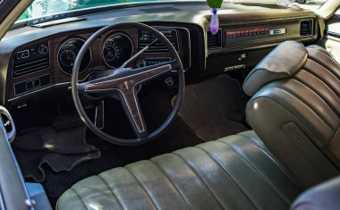 The interior of an old car. Steering wheel and dashboard