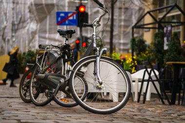 Bike stands in the parking lot in front of a street cafe