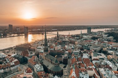 RIga rooftop view panorama at sunset with urban architectures and Daugava River.