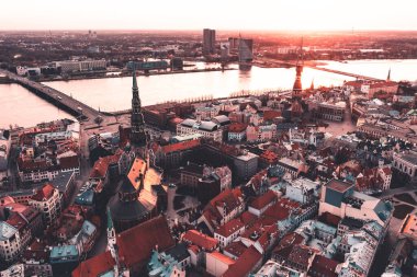 RIga rooftop view panorama at sunset with urban architectures and Daugava River.