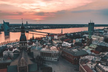 RIga rooftop view panorama at sunset with urban architectures and Daugava River.