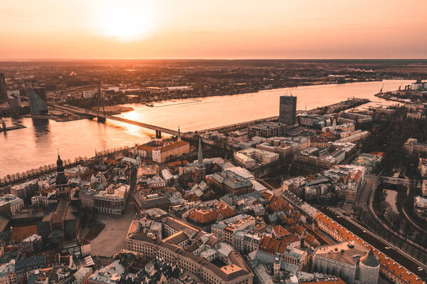 RIga rooftop view panorama at sunset with urban architectures and Daugava River.
