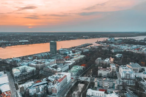 RIga rooftop view panorama at sunset with urban architectures and Daugava River.