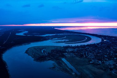 aerial view over the Gauja river outfall, coastline and blue sea