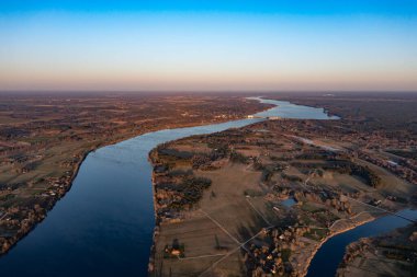 incredibly beautiful nature on a bright spring day by the river. Hilly landscape, steep banks of the river. bright positive juicy green lawn. weather after rain