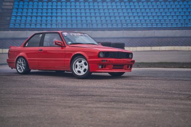 01-05-2021 Riga Latvia Side view of cherry red sedan parked