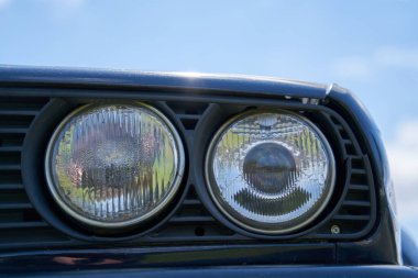 Round headlight on a old BMW car.