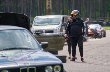 21-05-2021 Riga, Latvia A Helmeted Race Car Driver At The Wheel.