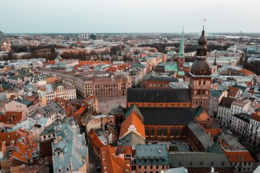 RIga rooftop view panorama at sunset with urban architectures and Daugava River.